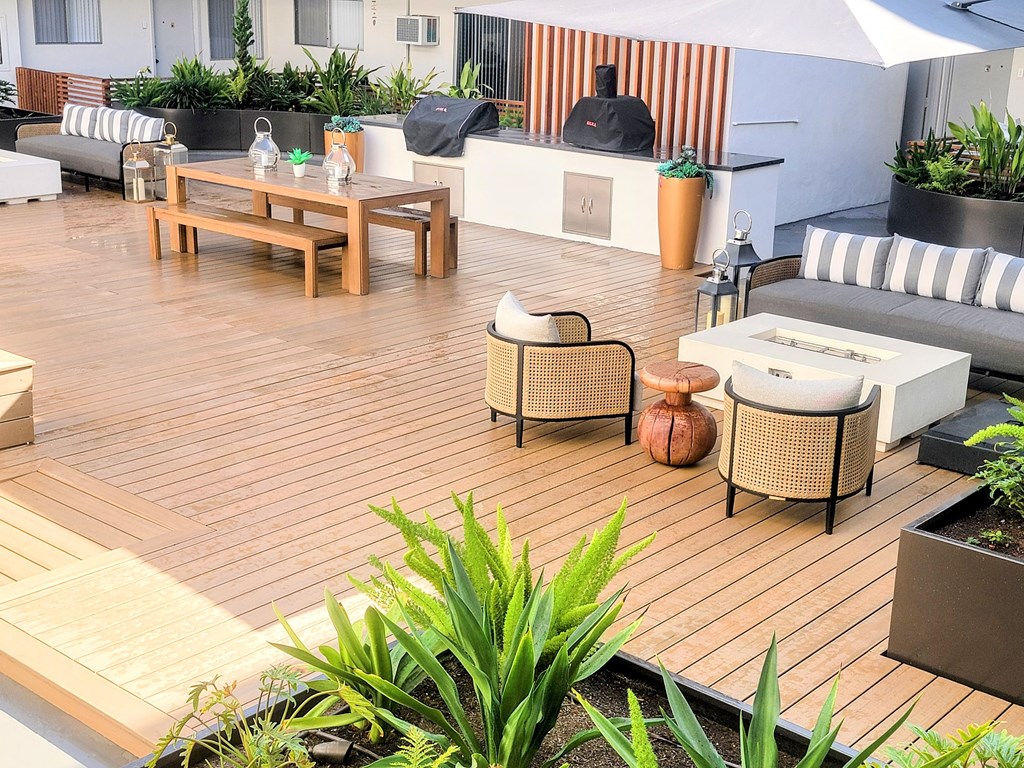 A wooden deck with furniture and plants.