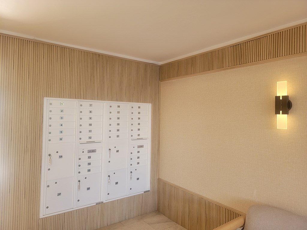 A wall with a calendar and a light switch.