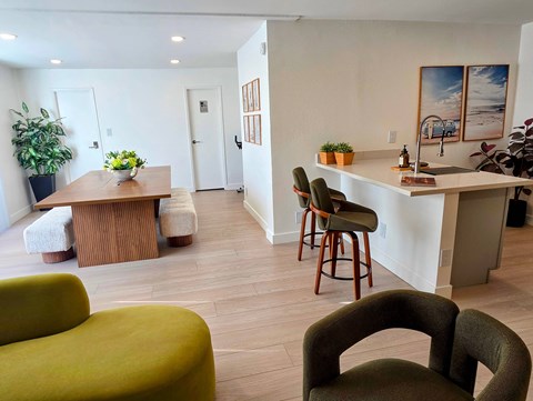 A living room with a green couch and a wooden table.