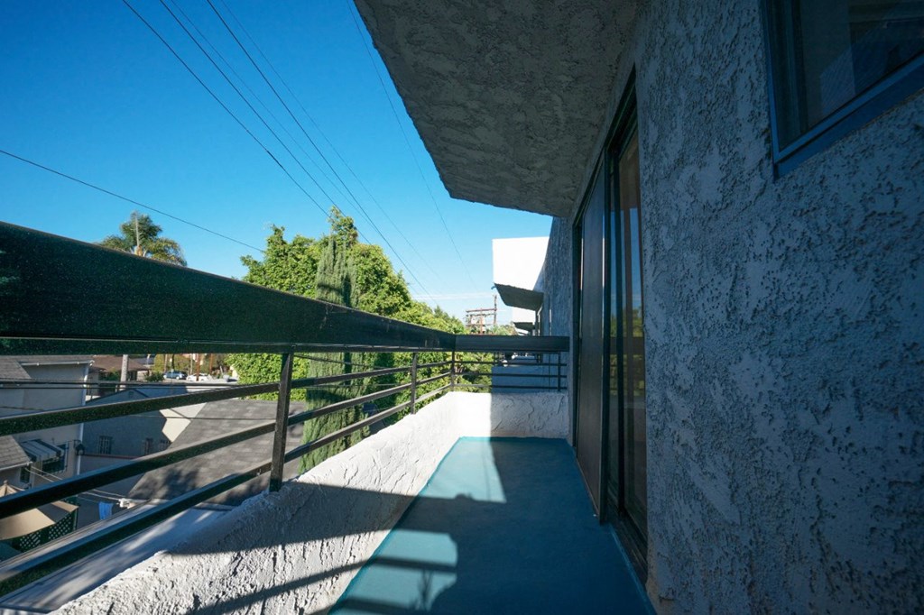 the balcony of the building has a view of the city