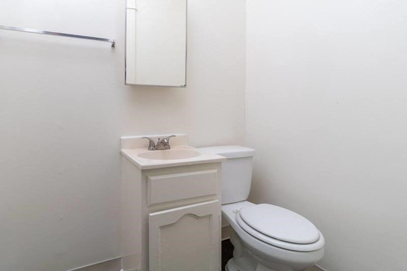 an empty bathroom with a toilet and a sink