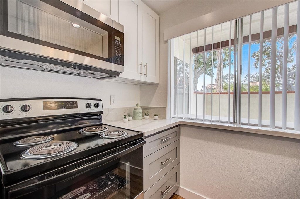 a kitchen with a stove and a microwave