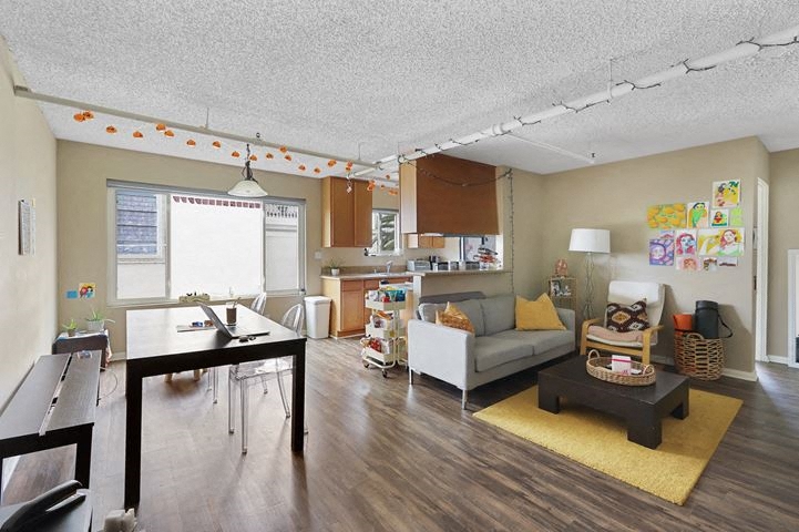 a living room with a kitchen and a table