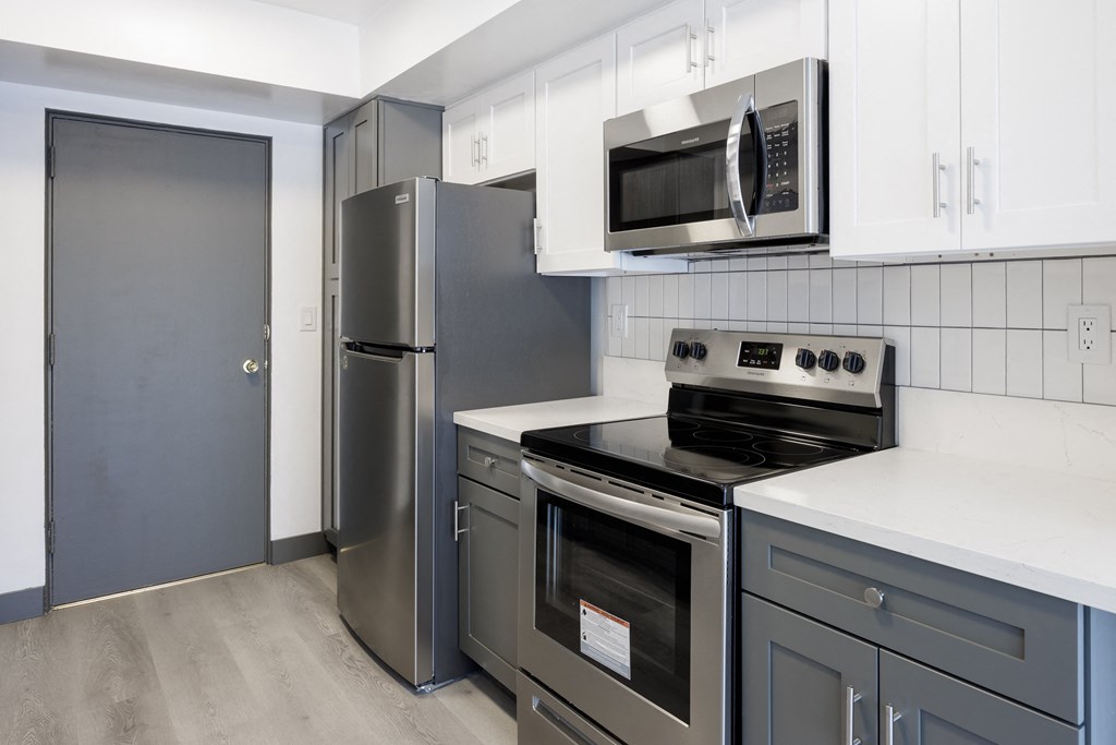 a kitchen with stainless steel appliances and white cabinets