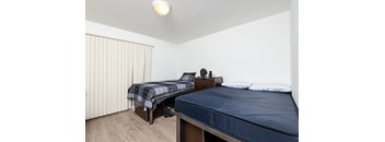 a bedroom with two beds and a large window