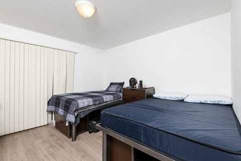 a bedroom with two beds and a large window