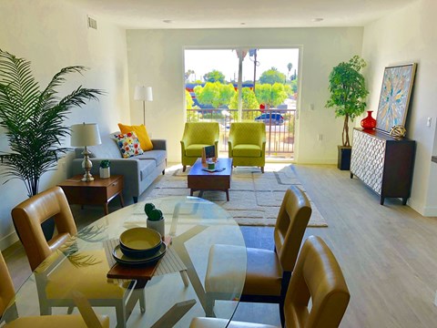 A modern dining room with a glass table and chairs.