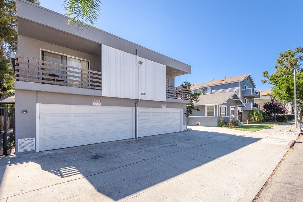 A two-story house with a white garage door.