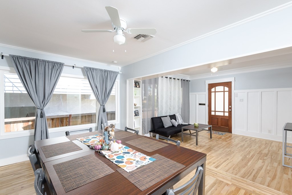 A dining room with a table set for four.