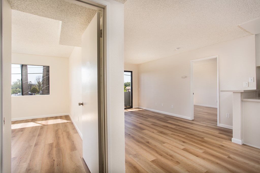 A room with wooden floors and white walls.