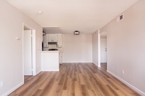 A kitchen area with a white counter and cabinets.