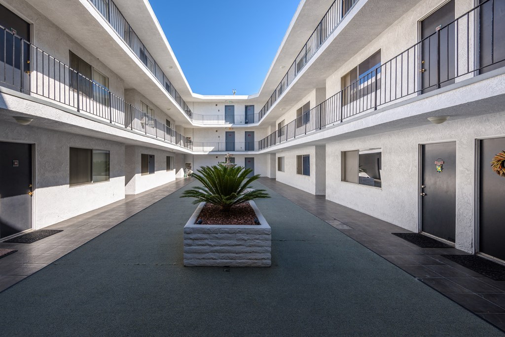 a large concrete planter sits in the middle of a courtyard