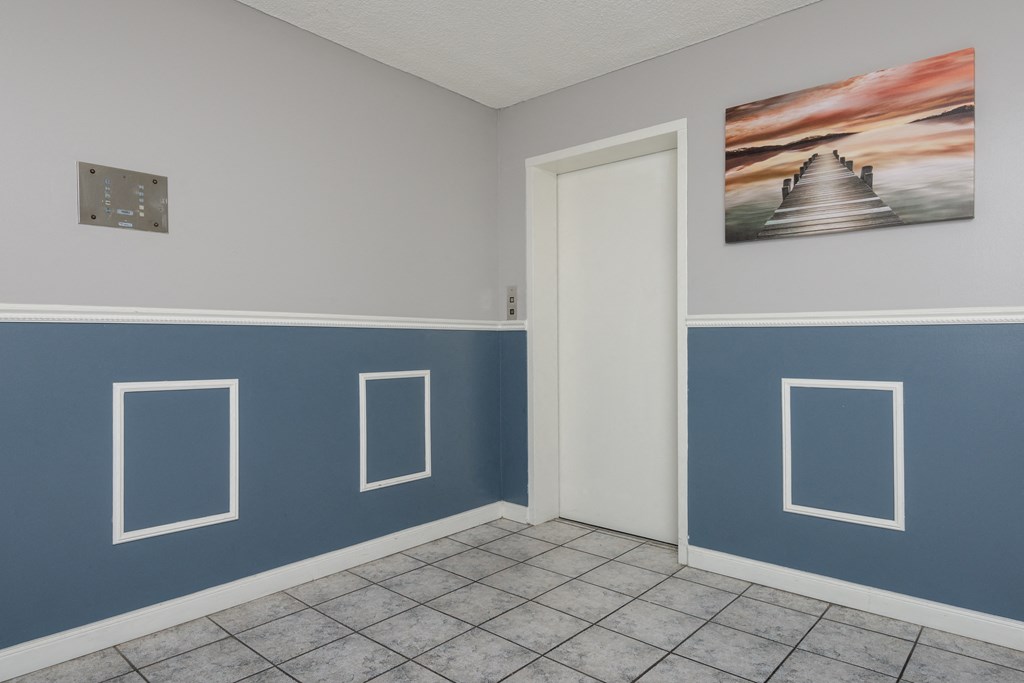 a room with blue walls and a painting on the wall