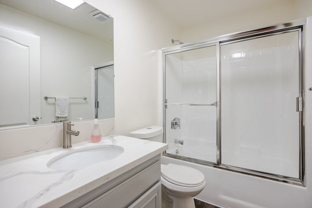 a bathroom with a sink toilet and shower