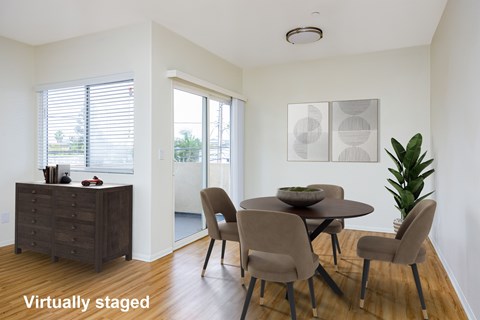 A dining room with a table set for four.