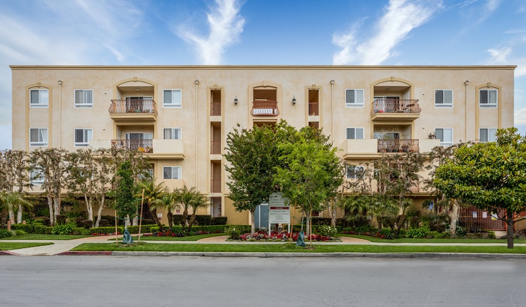 a large apartment building with trees in front of it