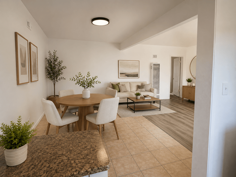 A dining room with a round table and chairs.