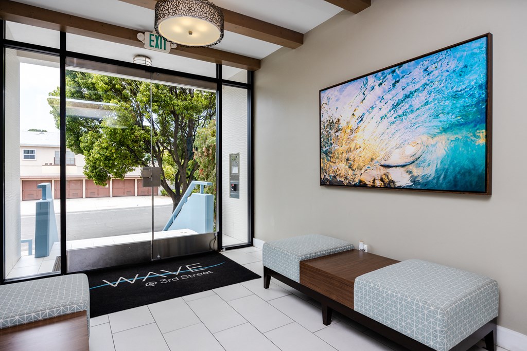 a living room with a couch and a large painting on the wall