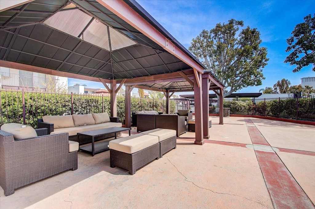 a patio with couches and a coffee table