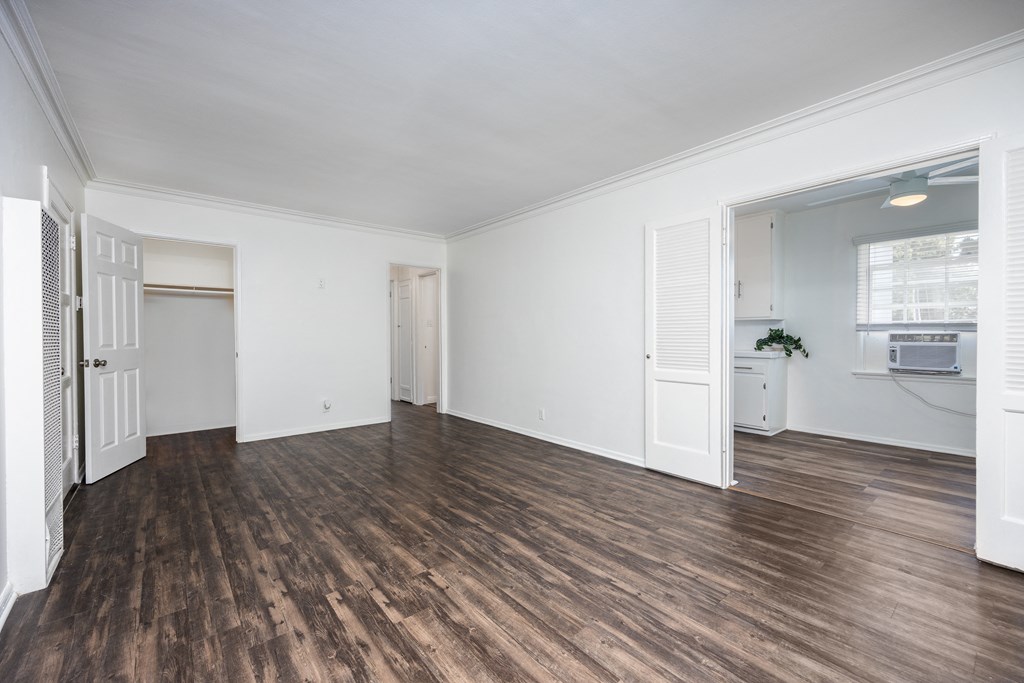a living room with hardwood floors and white walls
