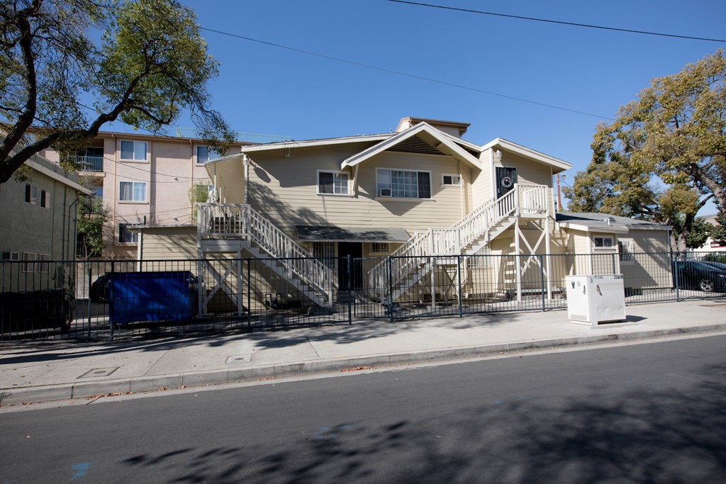 A house with a blue tarp on the stairs.