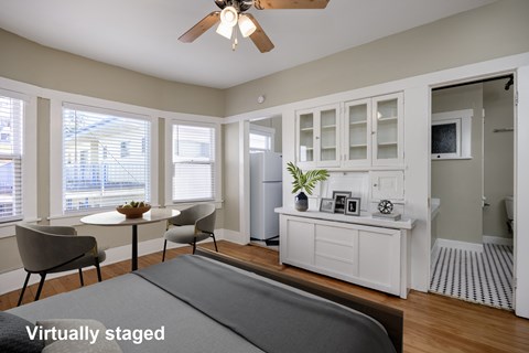 A living room with a grey sofa and a white cabinet.
