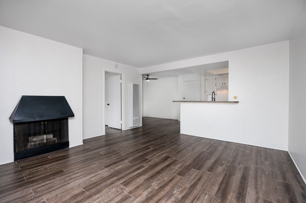 a living room with white walls and a fireplace
