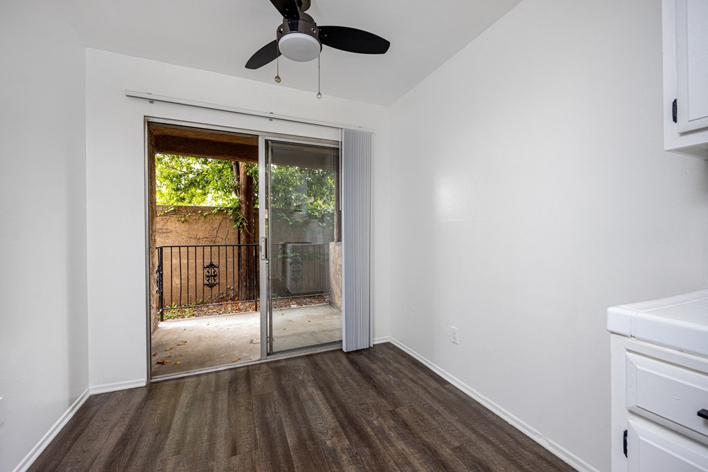 an empty room with a sliding glass door to a yard