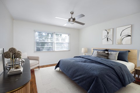 a bedroom with a bed and a ceiling fan