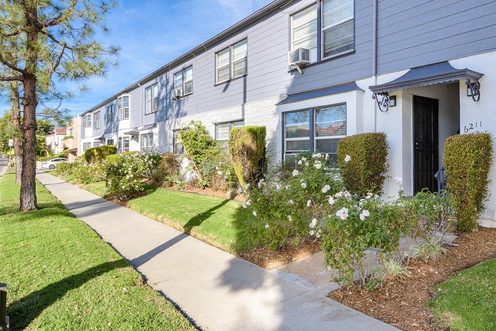 a white house with a sidewalk in front of it