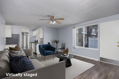 A living room with a grey couch and a blue chair.