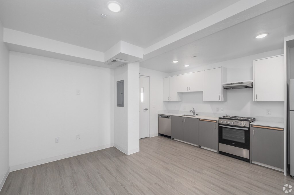 A kitchen with white cabinets and stainless steel appliances.