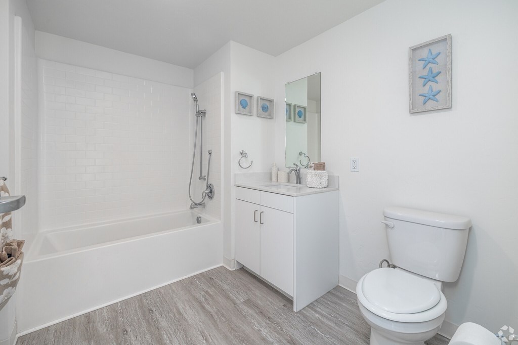 A white bathroom with a toilet, a sink, and a bathtub.