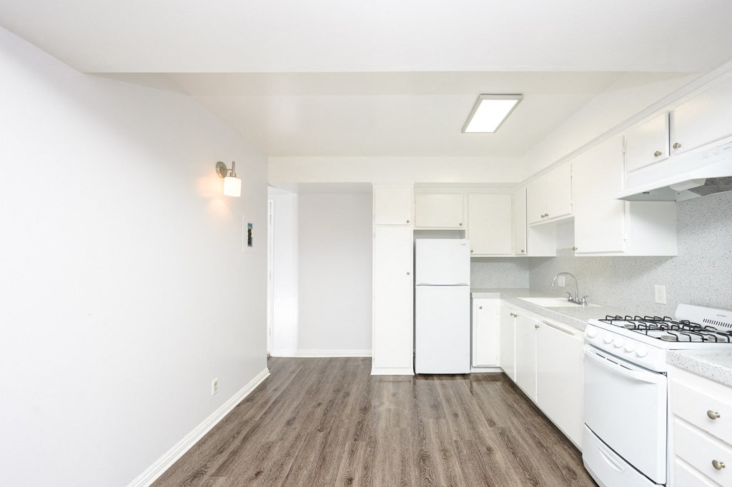 a kitchen with white appliances and white cabinets