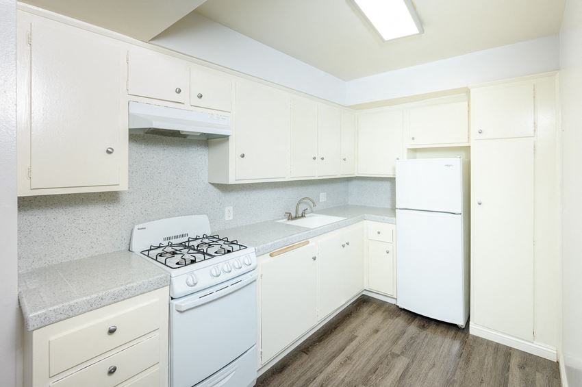 a kitchen with white appliances and white cabinets - Photo Gallery