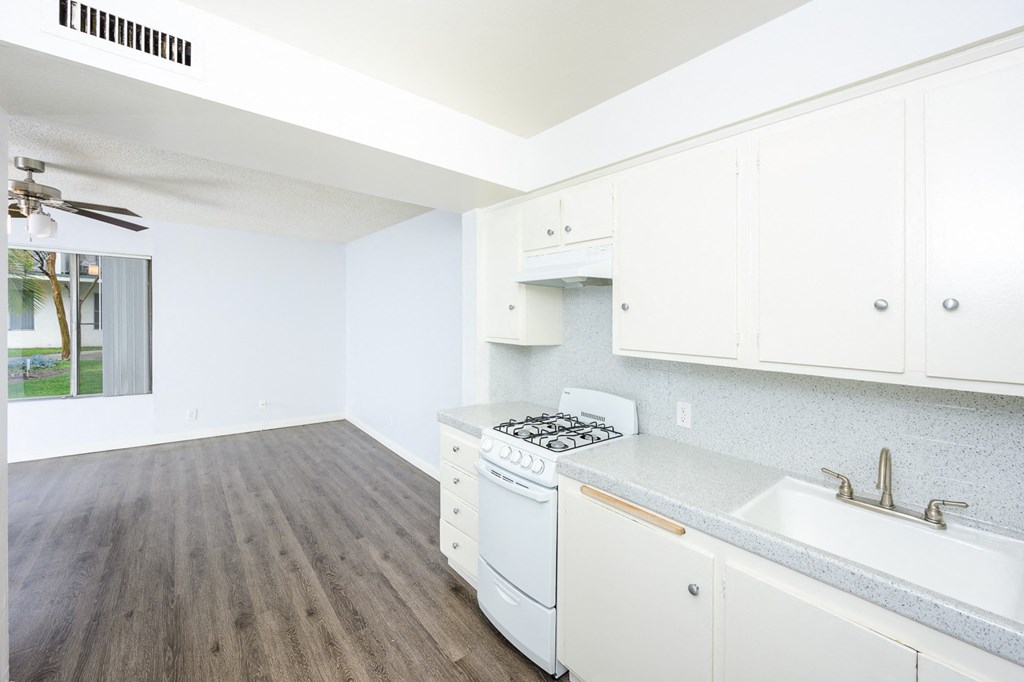 a white kitchen with white appliances and white cabinets
