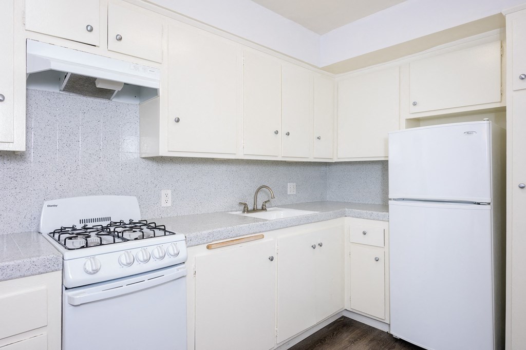 a kitchen with white appliances and white cabinets