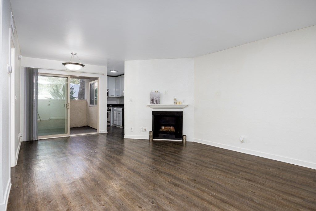 a living room with white walls and a fireplace