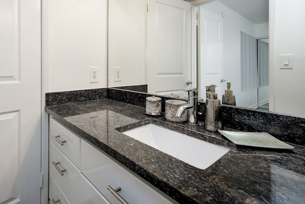 a bathroom with a sink and a mirror
