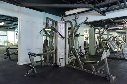 A gym with a variety of equipment including a leg press machine.