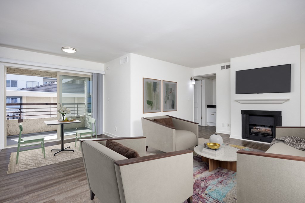 a living room with couches and chairs and a fireplace