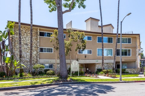 a large apartment building with a sign in front of it