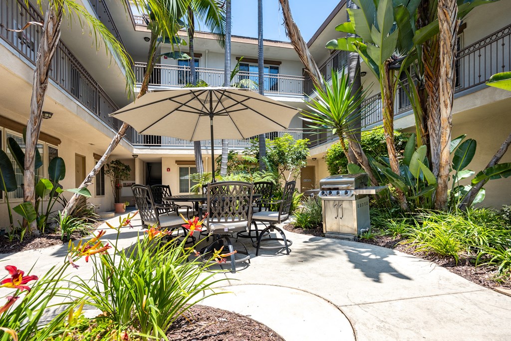a patio with a table and chairs and an umbrella