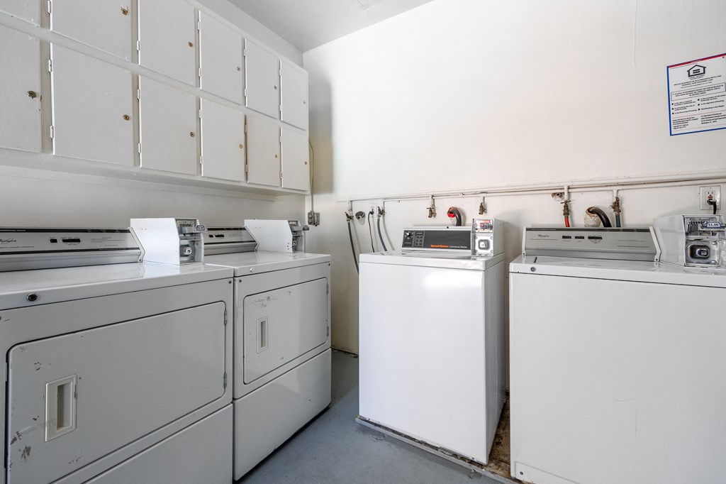 a kitchen with white appliances and white cabinets