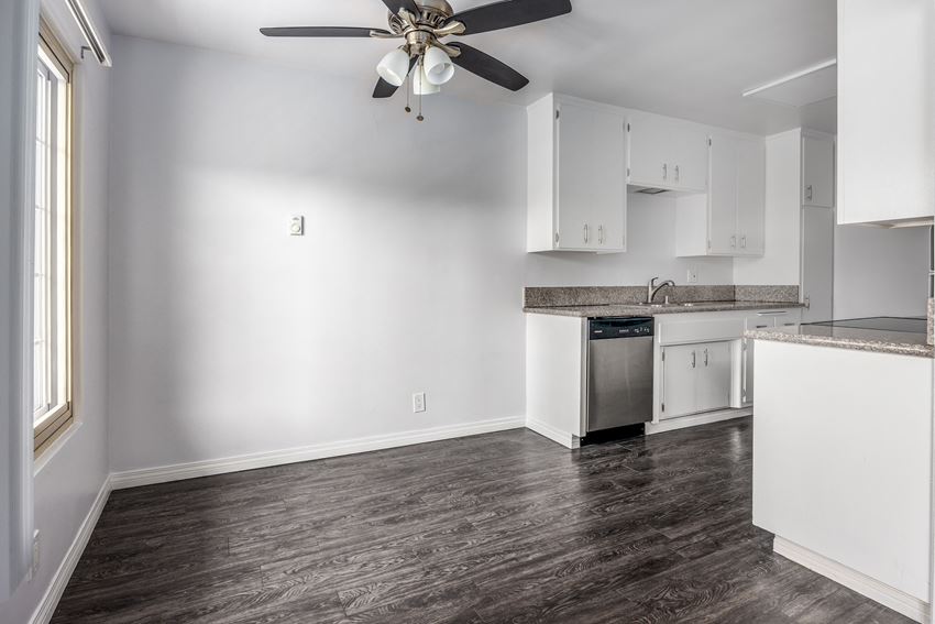 a kitchen with white cabinets and a ceiling fan - Photo Gallery