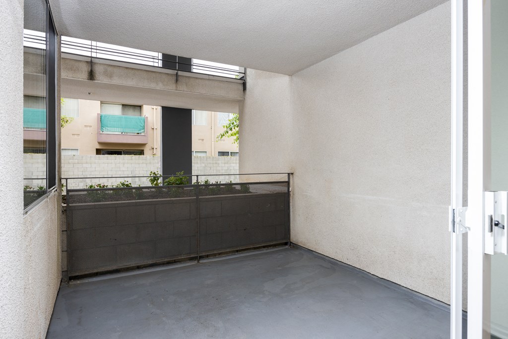 a balcony with a railing and a large window