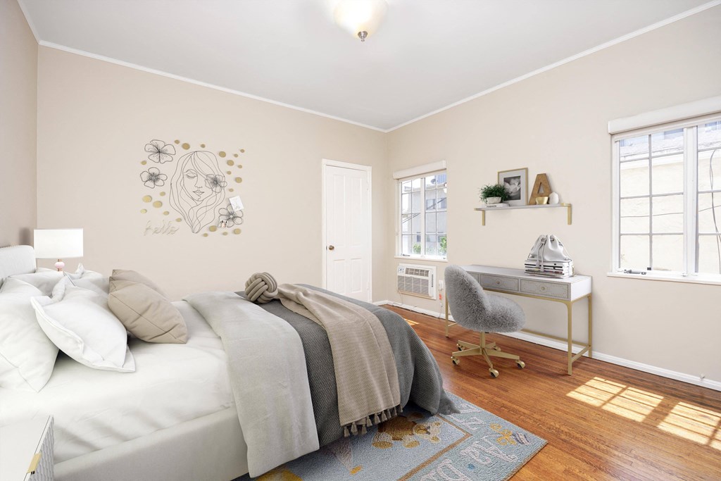 a bedroom with a bed and a desk with a chair