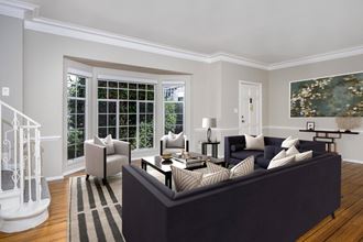 a living room filled with furniture and a large window