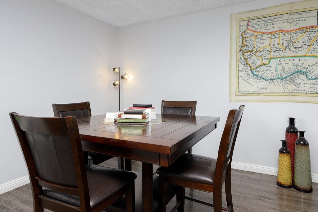 a dining room with a table and chairs and a map on the wall
