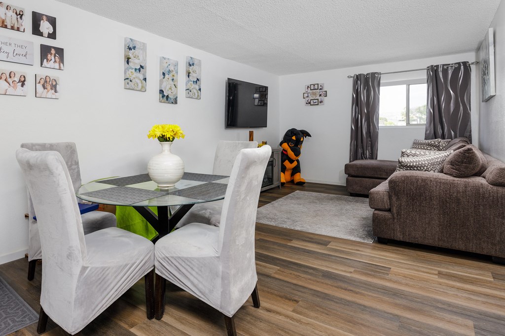 a living room with a table and chairs and a tv